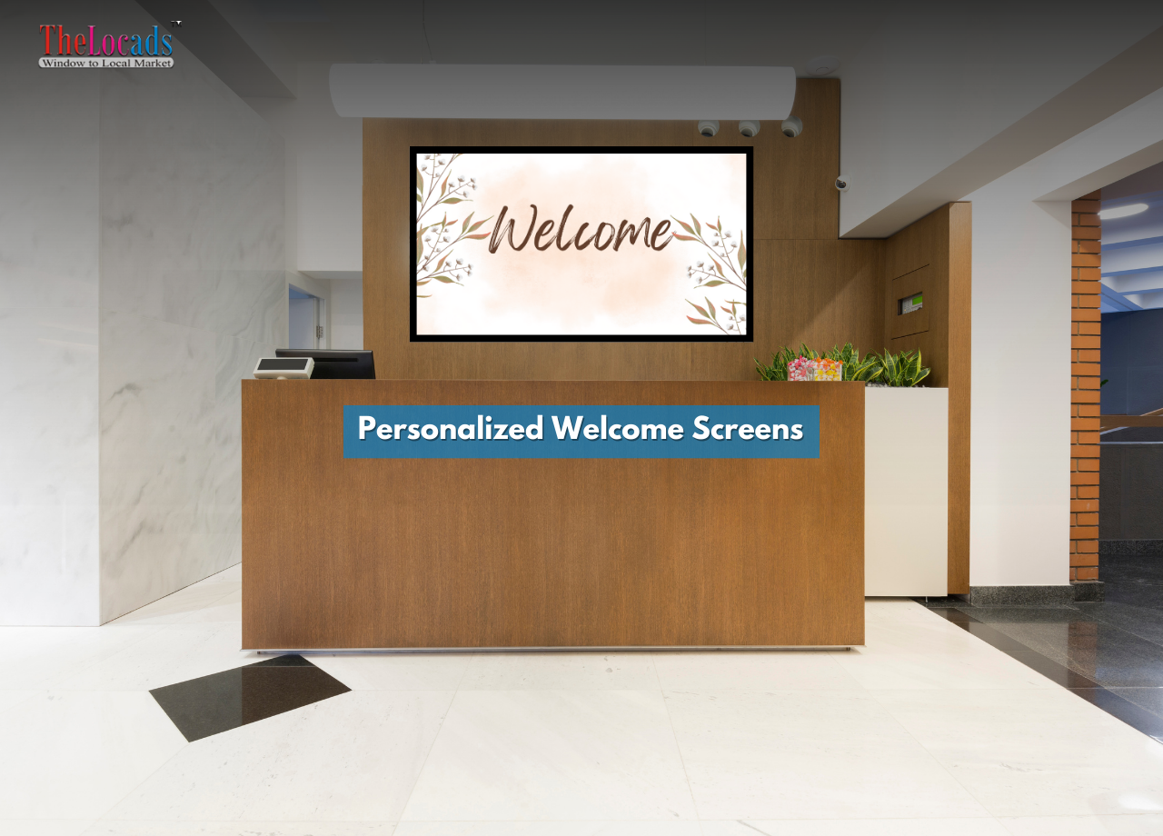 Digital welcome screen at a reception desk displaying a personalized greeting in a professional office environment.